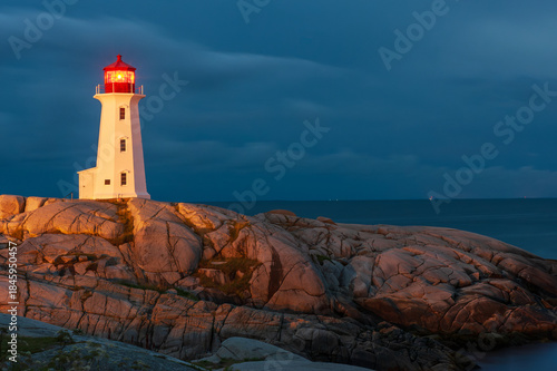 Famous Peggy's Point Lighthouse illuminated at night, Nova Scotia, Canada