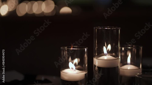 Stacked Glass Votive Candles Flickering On Dining Table Tiered Centerpiece With Reflective Surfaces Warm Glow Soft Bokeh Creating Tranquil
