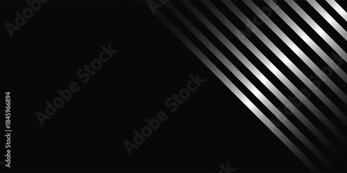 Abstract background with diagonal silver metallic stripes on a dark black surface, creating a modern and sleek design.