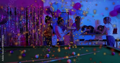 Friends with tray walking to counter, passing snacks near pool table for events as confetti rising