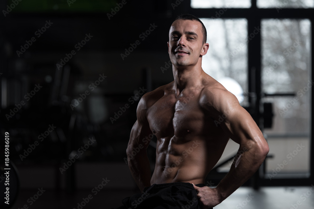 Fototapeta premium Young Bodybuilder Flexing Muscles