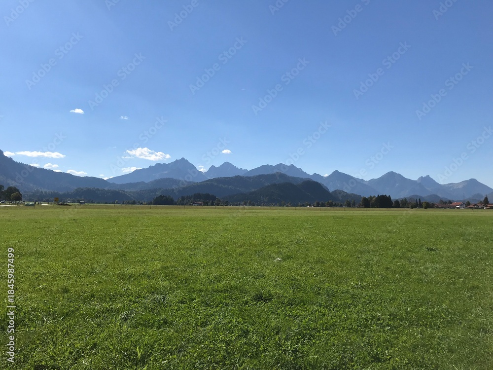 Fototapeta premium Peaceful Alpine Landscape under Clear Blue Sky