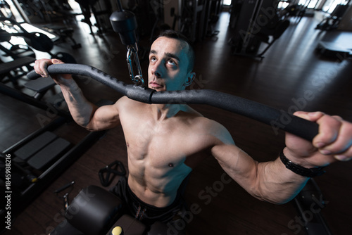 Muscular Man Doing Heavy Weight Exercise For Back