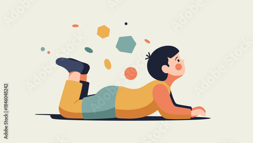 A little boy lies on his stomach looking up at colorful shapes in a playful illustration