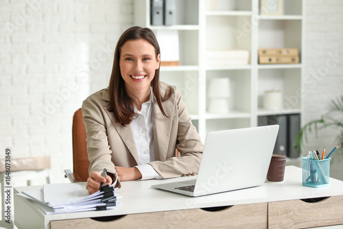Young businesswoman working at desk in office