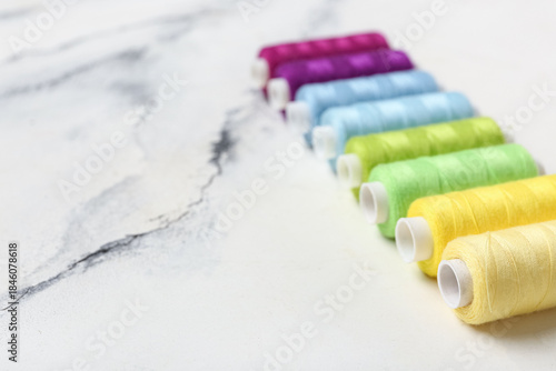 Row of colorful thread spoo...