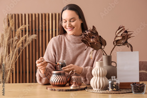 Young woman pouring dry tea...