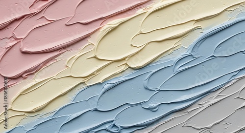 A close-up view of thick, creamy pastel paint smears creating a diagonal artistic pattern