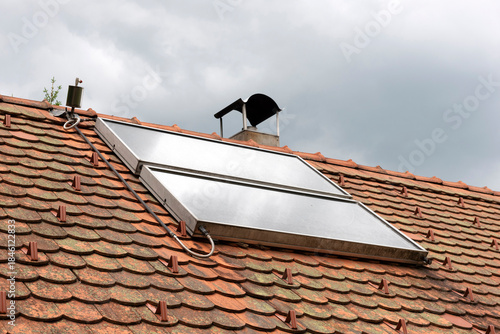 Solar water heater system on roof top showcasing sustainable energy, eco-friendly technology for home or building.