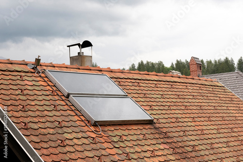 Solar water heater system on roof top showcasing sustainable energy, eco-friendly technology for home or building.
