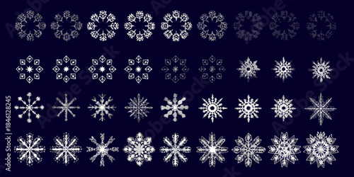 An array of delicate white snowflake patterns against a dark blue backdrop