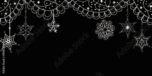 Intricate black and white snowflake decorations hanging against a dark background