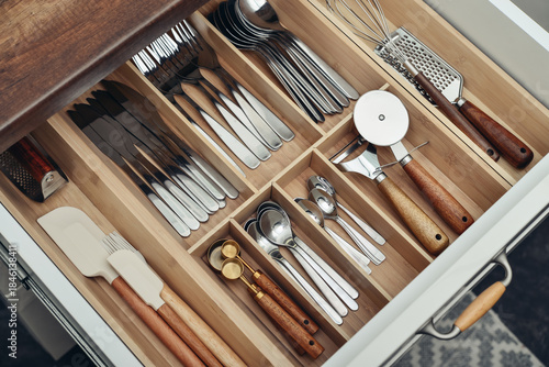 Bild auf Leinwand Bamboo organizer with cutlery in kitchen drawer