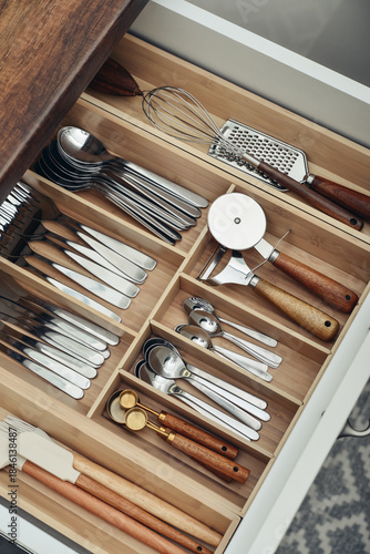 Bamboo organizer with cutlery in kitchen drawer