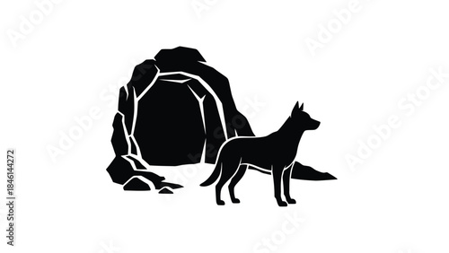 A silhouetted dog standing near a rocky cave entrance in black and white