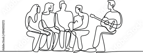 Group of people sitting and listening to a man playing guitar