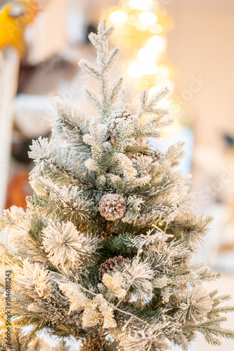 Blue Christmas tree with snowflakes falling on its branches