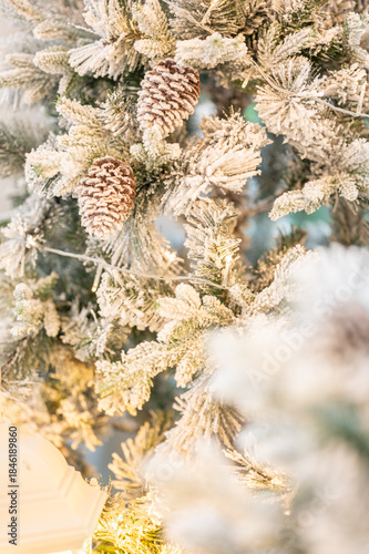Blue Christmas tree with snowflakes falling on its branches