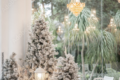 Blue Christmas tree with snowflakes falling on its branches