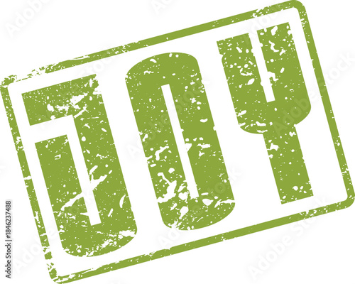 Distressed green rubber stamp impression featuring the inspiring word JOY prominently displayed on a clean surface
