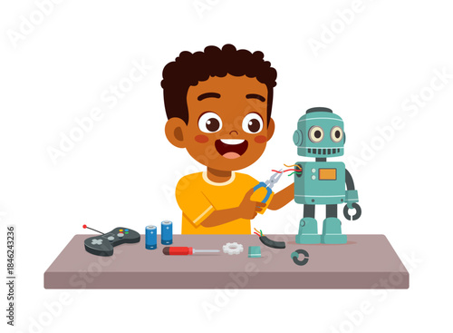 Happy African American boy fixing robot with pliers on a table showing engineering interest