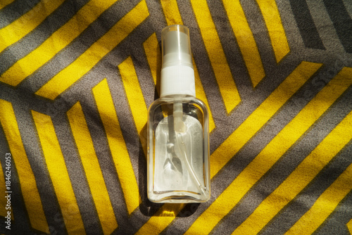 Konstfotografi Transparent Spray Bottle on Chevron Fabric Product Closeup
