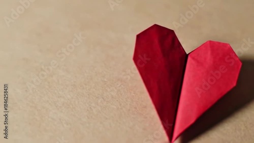 Wallpaper Mural Vibrant Red Origami Heart on a Light Brown Textured Background. Handmade Paper Craft Symbolizing Love, Romance, and Affection for Valentine's Day. Torontodigital.ca