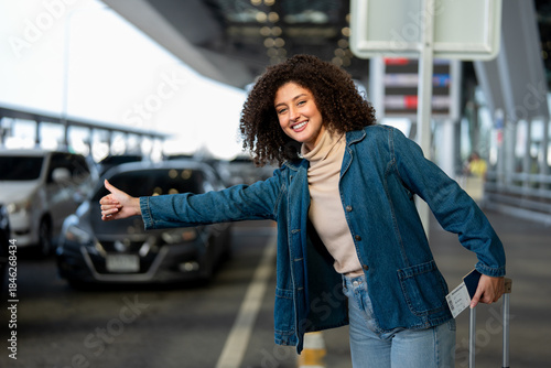 Latino woman passenger waiting public car outside airport terminal. 