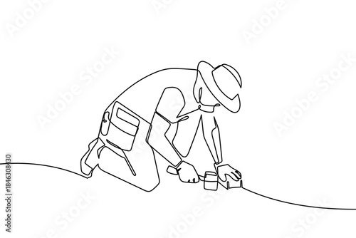 Along the first line, a construction worker is laying bricks for a walkway. Single line draw design vector graphic illustration Editable stroke.