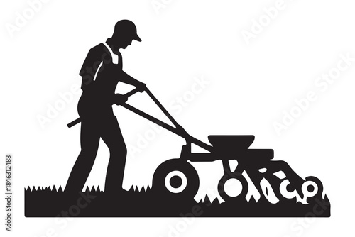  A silhouette of a farmer pushing a push-behind agricultural machine in a field
