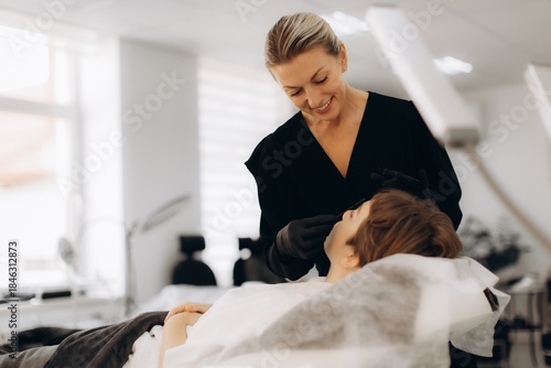 Beautician performing skincare treatment on client face