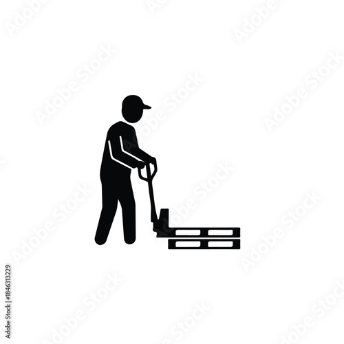 Warehouse worker operating a pallet jack to lift wooden pallets