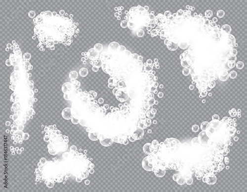 Soap bubbles, displaying unique designs, gracefully float on a plain gray surface