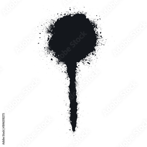 Round black paint spot with splashes created by a spray can on a white surface showing marks from paint.