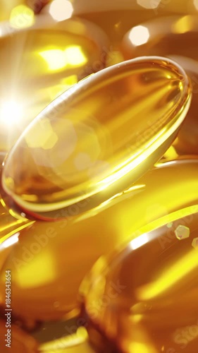 Macro shot of yellow transparent capsules glowing in warm light. Pharmaceutical animation highlighting fish oil, omega-3 supplements and wellness products