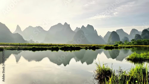 Karst Mountains with Mirrored Water Reflection at Early Morning