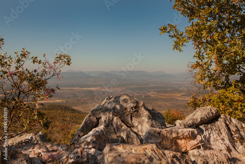 Panoramic view from the top of Mount Križevac in Medjugorje with the iconic cross overlooking the town, a sacred pilgrimage site symbolizing Christian faith, prayer, and spiritual reflection.