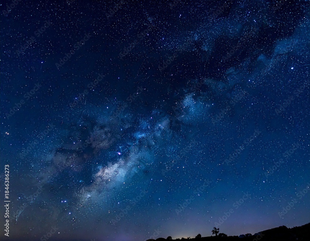 Fototapeta premium Astonishing Milky Way Galaxy view against a deep blue twilight sky with vibrant stars and nebulae