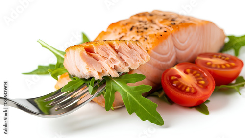 Healthy and delicious grilled salmon fillet served with fresh arugula and ripe tomatoes