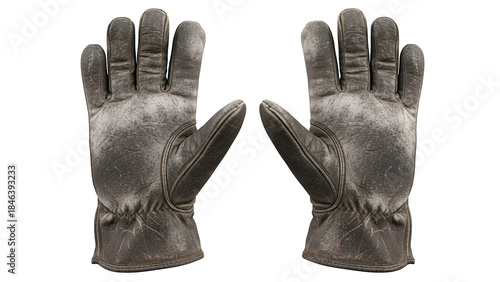 A pair of rugged dirty work gloves used for tough jobs showing significant wear