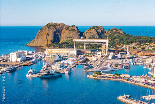 Industrial maritime port with cranes, docks, and yachts in La Ciotat on the Mediterranean coast. Southern France coastal city