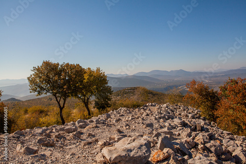 Panoramic view from the top of Mount Križevac in Medjugorje with the iconic cross overlooking the town, a sacred pilgrimage site symbolizing Christian faith, prayer, and spiritual reflection.