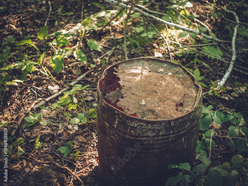 Old metal barrel in the forest