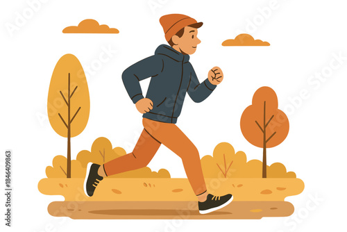 A young, fit man jogs through the park on a chilly autumn morning