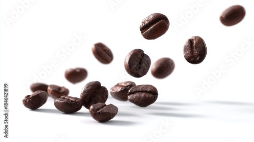 Floating roasted coffee beans in mid-air against plain background