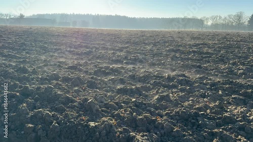 mist evaporating from agricultural field in winter sun