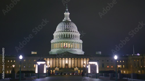 Capitol dome lit brightly. Congress hall at night. Iconic DC night scene. Capitol facade illuminated. Washington night architecture. Capitol at evening glow.