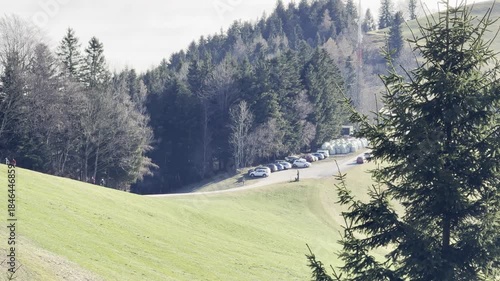 parking cars with sunseeking people fleeing foggy valley
