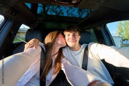 Romantic couple enjoying car road trip selfie