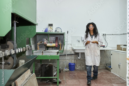 Fotografie Woman geologist in lab coat inspecting rock samples